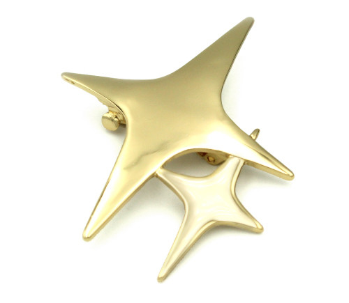 a gold star hairclip, featuring a large four-pointed star and a smaller four-pointed star at it's bottom right corner.