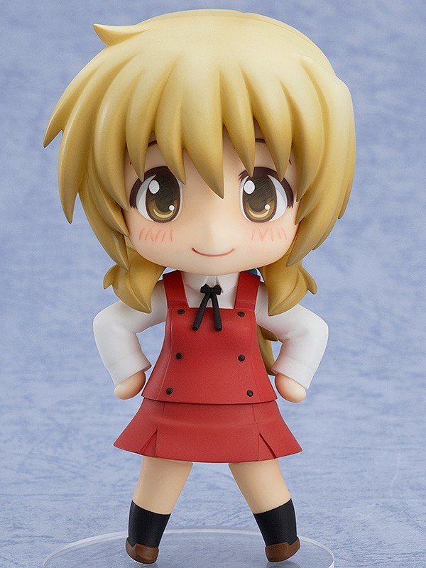 a nendoroid of miyako. she's a tall girl girl with medium length blonde hair tied back in a low ponytail with a green hair elastic. she's wearing her school uniform, one just like yuno's, as they are classmates.